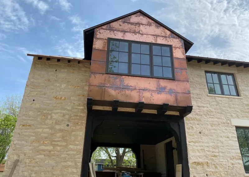 Copper metal panel facade on a stone building for Roof Repair in Freehold